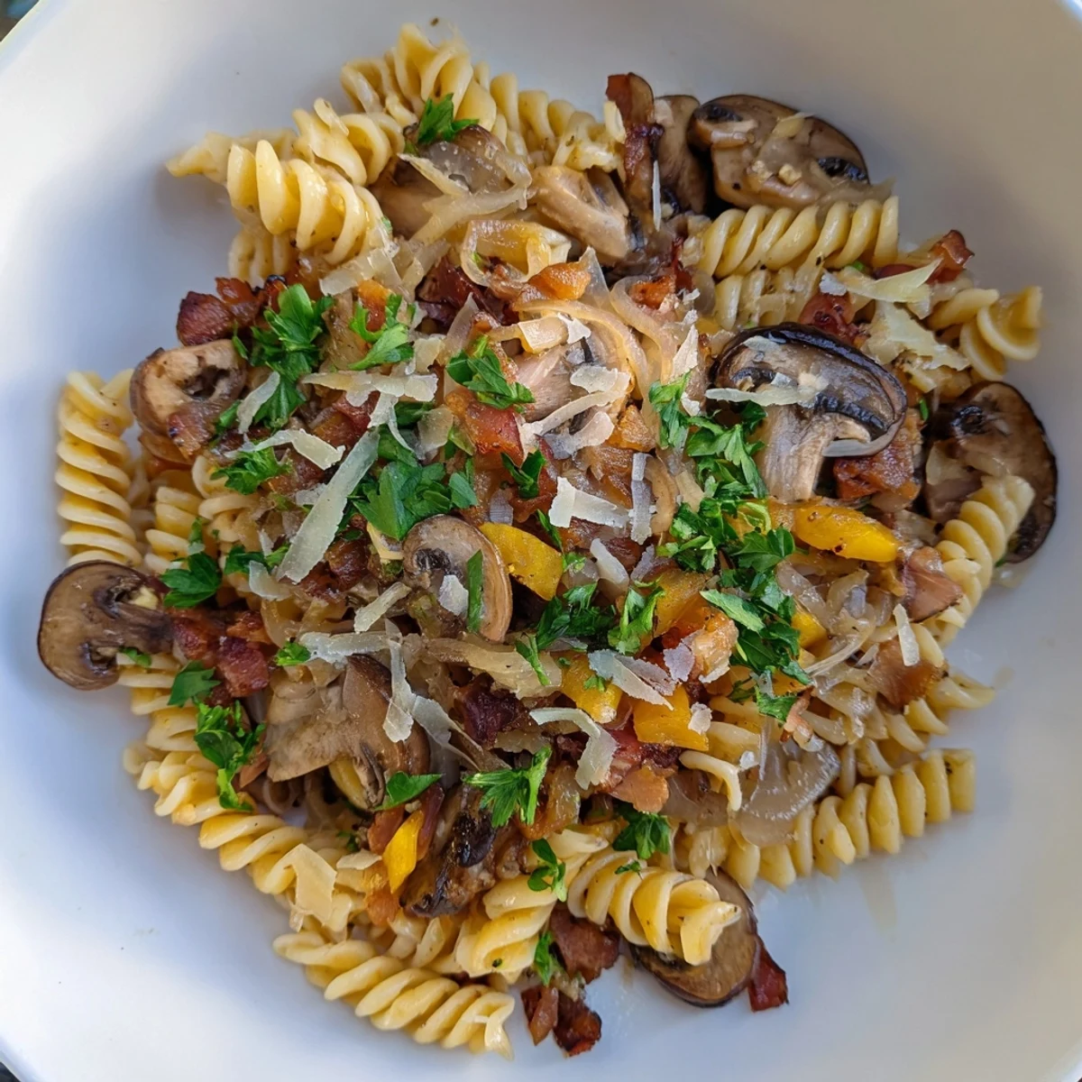 Golden, crispy bacon and earthy mushrooms mingle deliciously with fusilli in this savory dish.