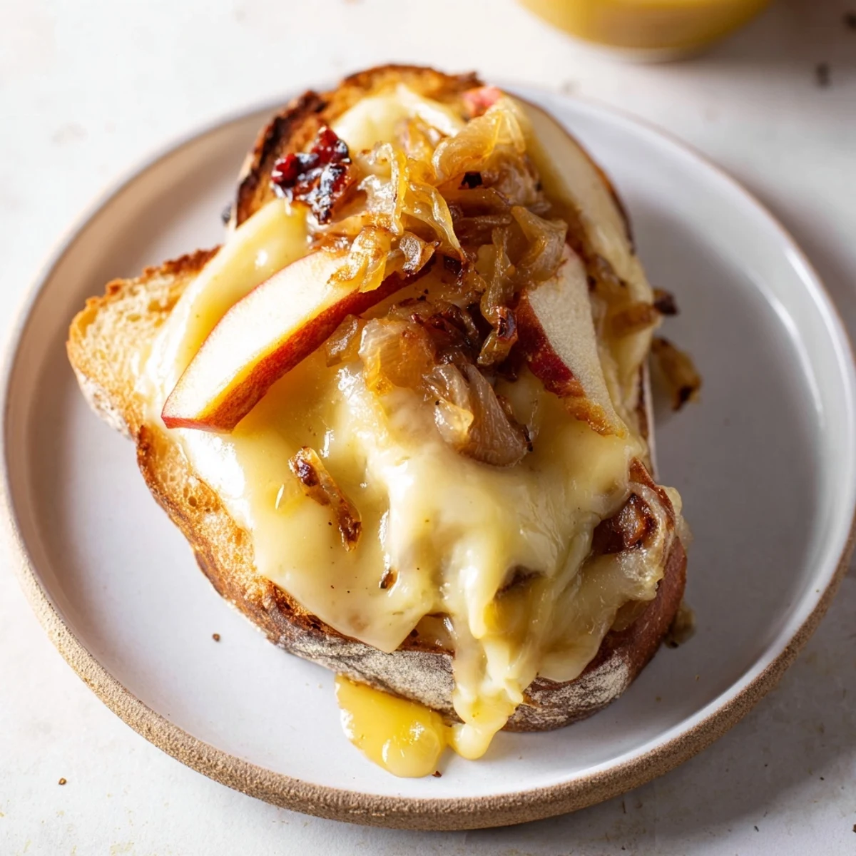 Golden-brown Caramelized Onion, Apple & Cheddar Grilled Cheese, perfectly melted and ready to eat.