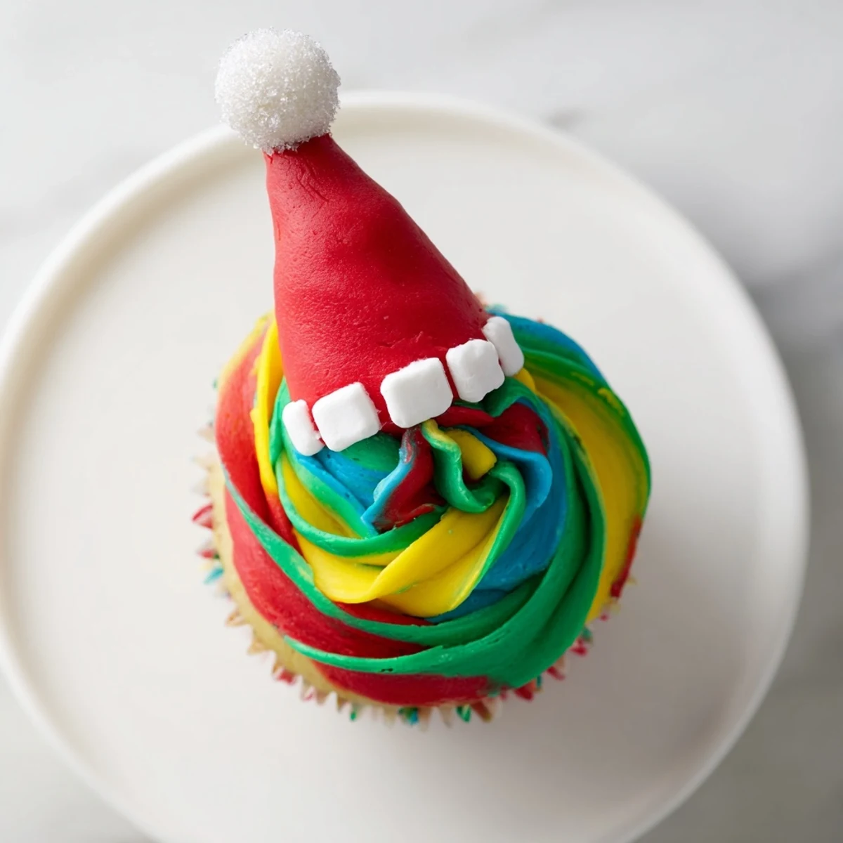 A tower of Elf Hat Cupcakes, invitingly frosted and topped with whimsical edible decorations.