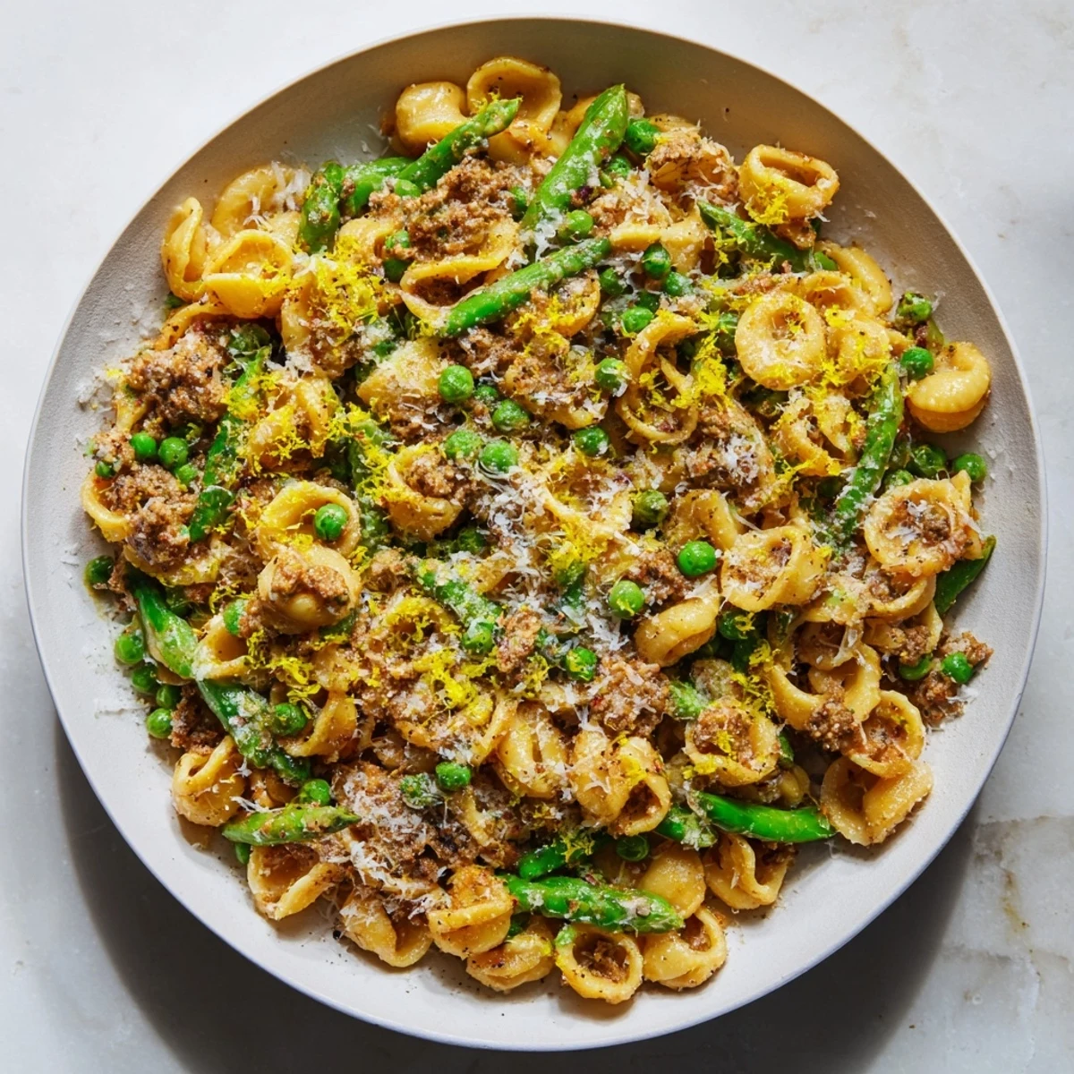 Steaming Garlic Butter Ditalini with Peas: a vibrant pasta dish with tender peas and parmesan.