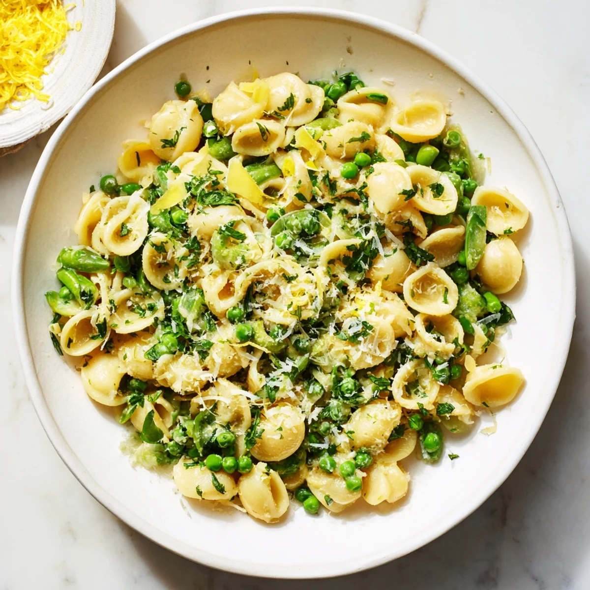 A close-up of Garlic Butter Ditalini with Peas, a delicious vegetarian pasta dinner, ready to serve.