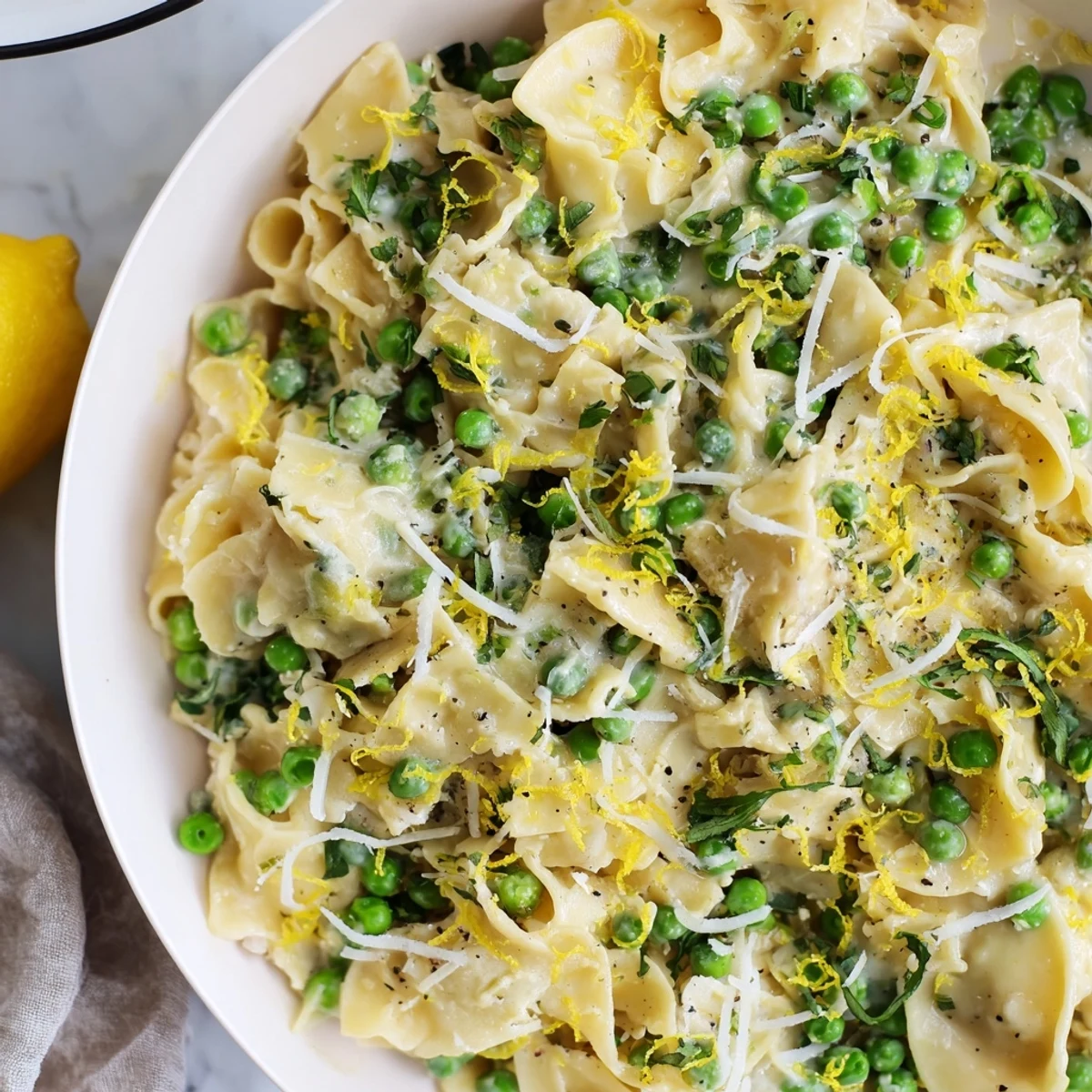 Tender ditalini pasta coated in garlic butter sauce, mixed with sweet peas, a comforting, warming meal.