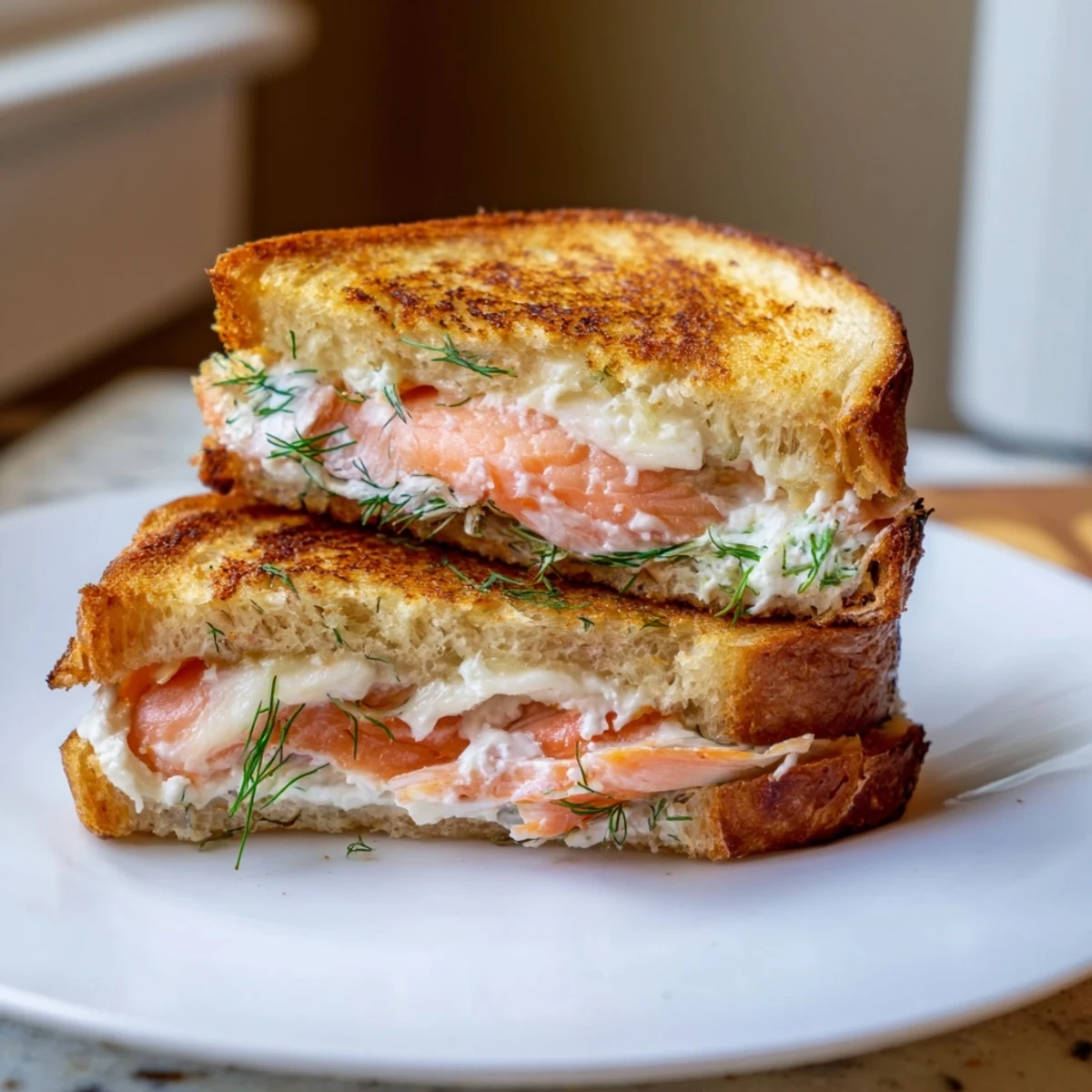 Golden, crispy Smoked Salmon Grilled Cheese sandwich, layered with salmon, creamy cheese, and fresh dill.
