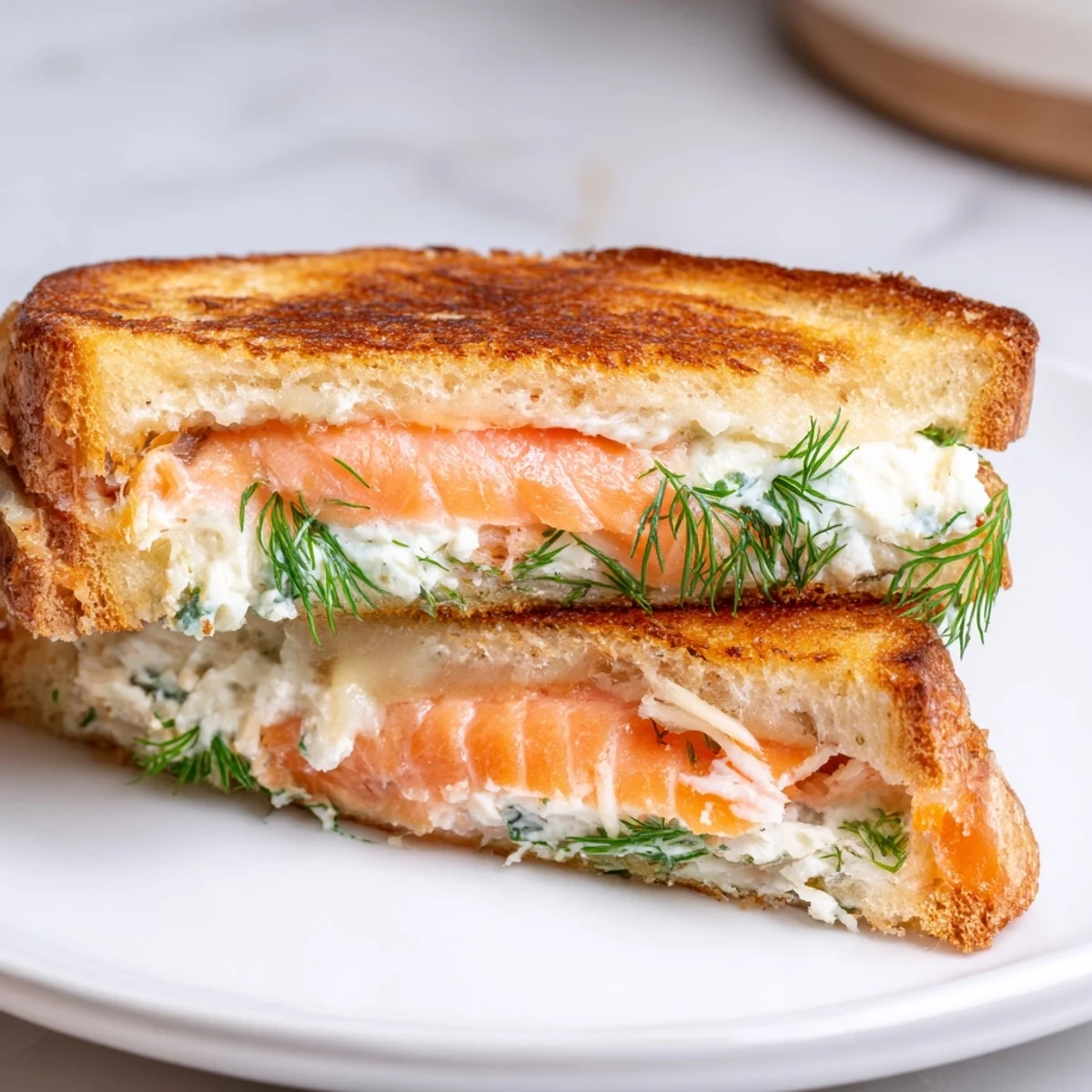Warm, melty Smoked Salmon Grilled Cheese, showcasing the perfectly grilled, buttery bread and delicious filling.