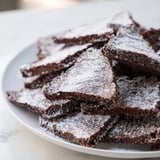 Warm, freshly-baked Chocolate Crinkle Cookies are pictured, perfect for holiday cookie trays.