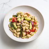 A refreshing Mediterranean White Bean Salad with Feta, ready to eat, topped with crumbled feta cheese.