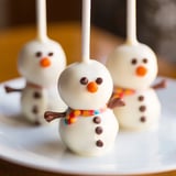 Festive Oreo Snowman Cake Pops, decorated with chocolate chips and pretzel arms, perfect dessert.