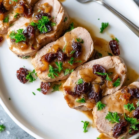 Cherry-Date Glazed Pork Tenderloin Slices, glistened with glaze, ready for a memorable meal.