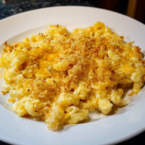 Golden brown, bubbly Old-Fashioned Baked Mac & Cheese with a cheese pull, perfect comfort food.