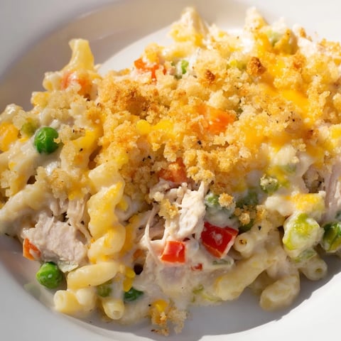 Creamy Chicken Macaroni Southern Style, topped with golden cheese and buttery crackers, bubbling.