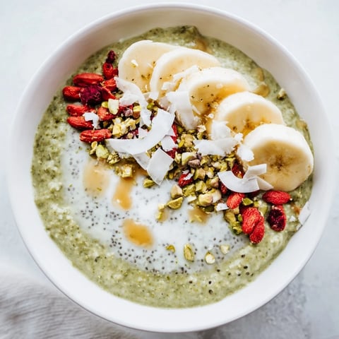 Creamy green Matcha Overnight Oats topped with fresh berries, perfect for a quick breakfast.