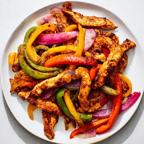 Sheet pan chicken fajitas bursting with savory peppers, onions, and perfectly cooked chicken.