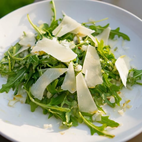 Fresh, peppery arugula salad with bright lemon dressing and shaved Parmesan, so flavorful.