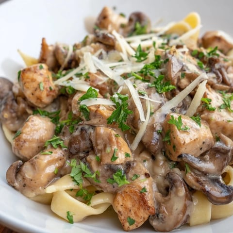 Steaming Creamy Mushroom Chicken Pasta featuring golden chicken and tender mushrooms, a beautiful dish.