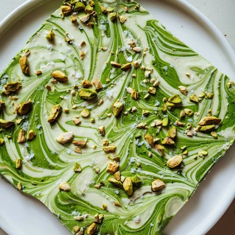Creamy Pistachio Matcha White Chocolate bark swirled with vibrant green matcha and crunchy pistachios, a dessert delight.