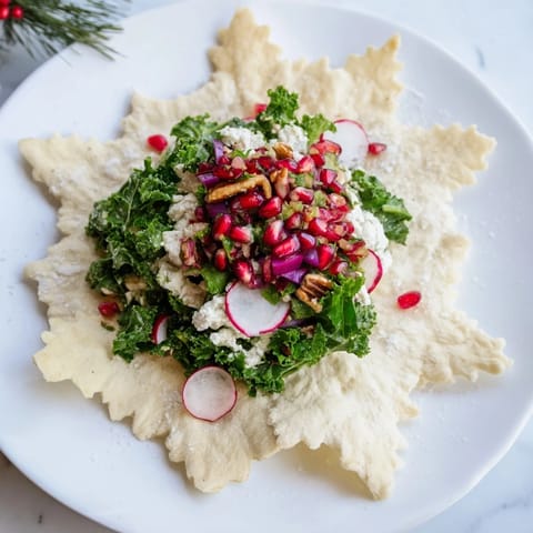 A close-up shot of a beautiful Winter Salad: crunchy snowflake tortilla chips alongside fresh greens and red salsa.