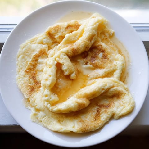 Delicious, one-bowl fluffy scrambled pancakes with blueberries, perfect for breakfast.
