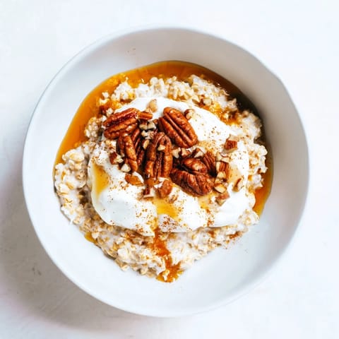 Warm, creamy Pumpkin Spice Latte Oats, a comforting fall breakfast with pecans and maple syrup.