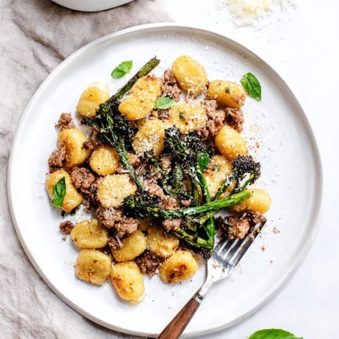 Hearty Sheet Pan Gnocchi Bake featuring pillowy gnocchi, savory sausage, and crisp-tender broccolini on a baking sheet.
