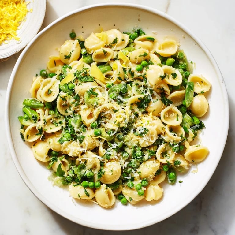 A close-up of Garlic Butter Ditalini with Peas, a delicious vegetarian pasta dinner, ready to serve.