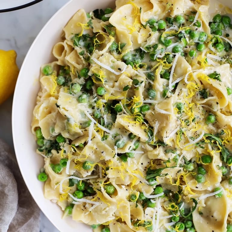 Tender ditalini pasta coated in garlic butter sauce, mixed with sweet peas, a comforting, warming meal.