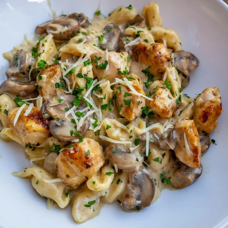 Savor the aroma of this Italian-American, creamy mushroom chicken pasta, perfectly plated and ready to eat.