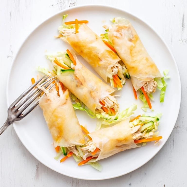Pan-fried Garlicky Pulled Chicken Wraps reveal savory shredded chicken and fresh veggie fillings inside.  
