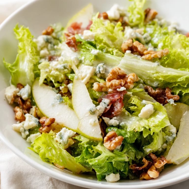 Tangy vinaigrette coats crisp frisée and ripe pears in this easy frisée, pear, blue cheese, and prosciutto salad.