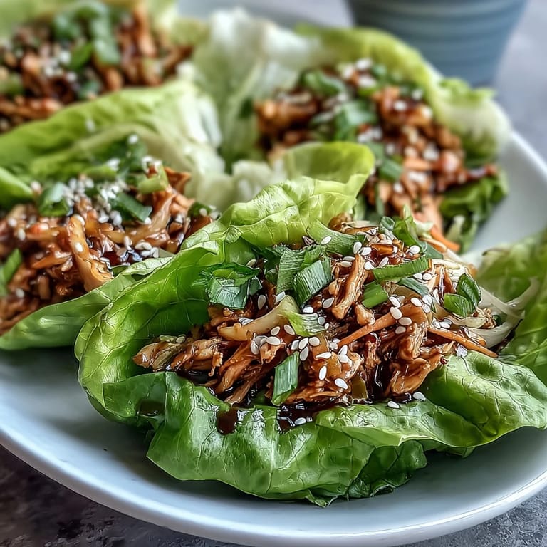 Steaming ground turkey and shirataki noodles in a wok for Potsticker Noodle Lettuce Cups, showcasing ginger, garlic, and soy sauce flavors.