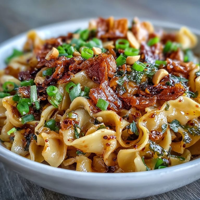 Aromatic Chili Crisp Noodles served hot, featuring a spicy, umami-rich sauce and fresh vegetables for a quick vegetarian dinner.