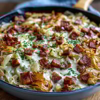 Creamy Cabbage and Ham Skillet with tender cabbage and savory ham in a rich, cheesy sauce, perfect for a comforting dinner.
